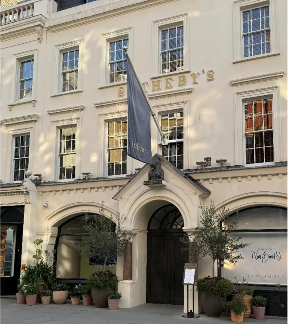 Elegant building with Sotheby's sign and flag.