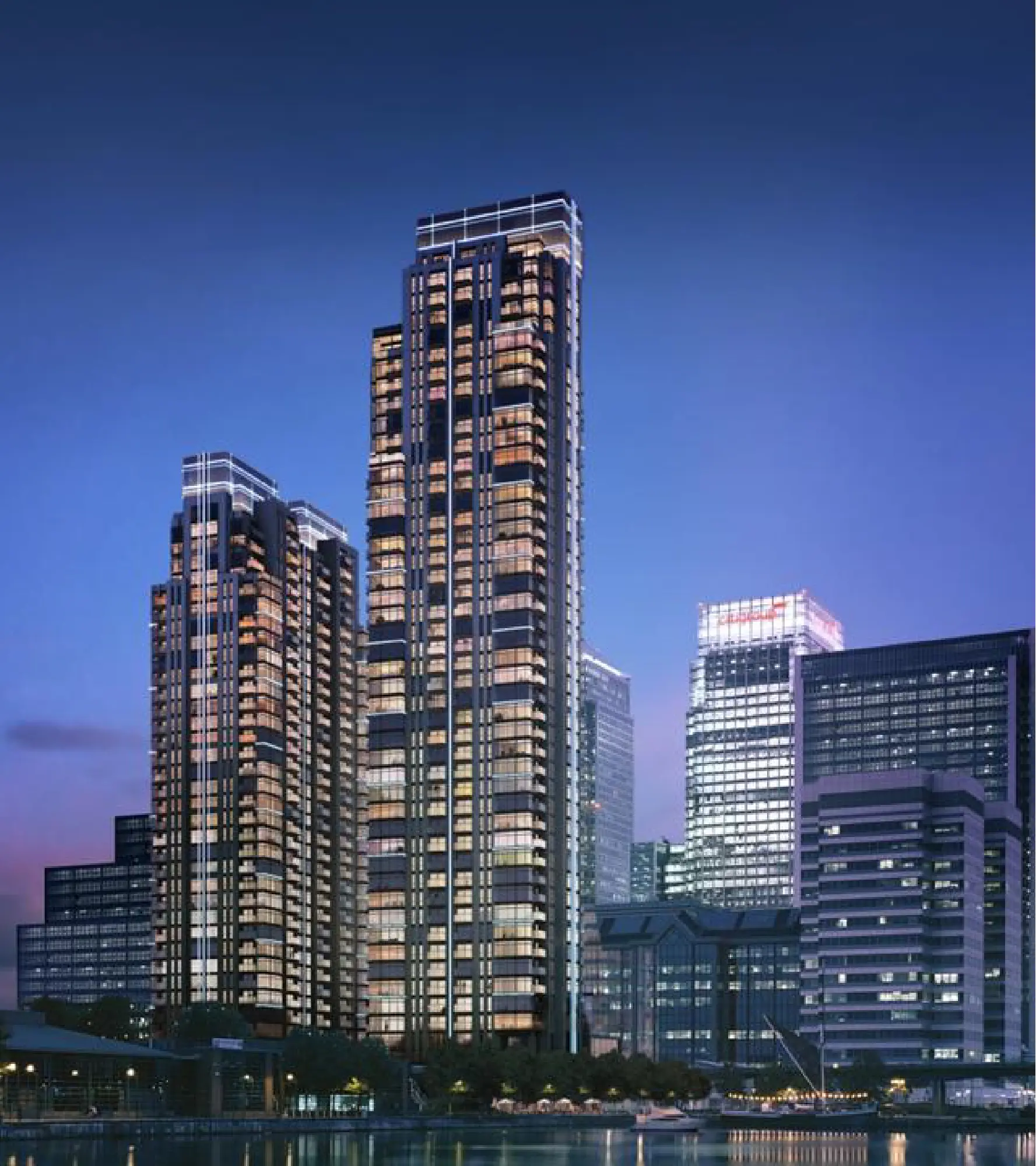 Skyscrapers illuminated at night against twilight sky.