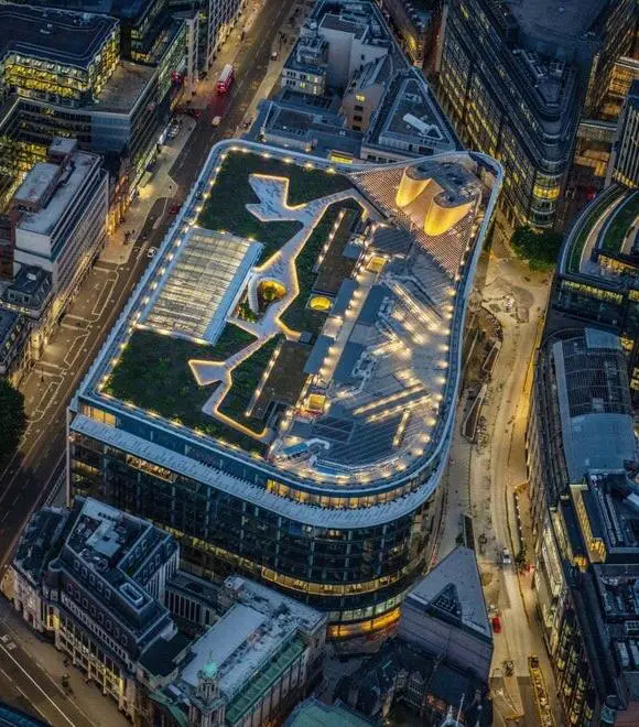 Aerial view of illuminated city building rooftop.