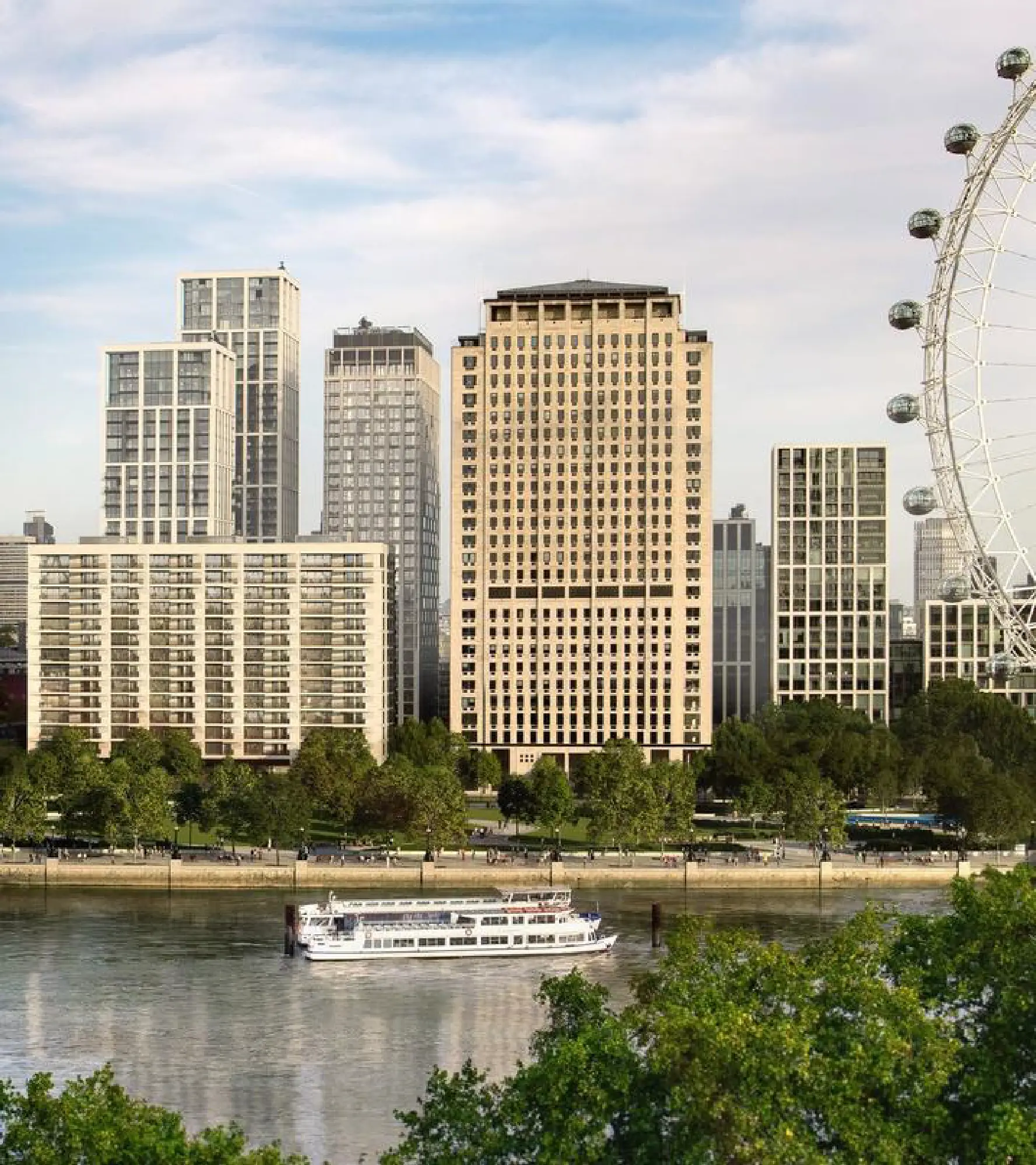 City skyline with river and Ferris wheel.