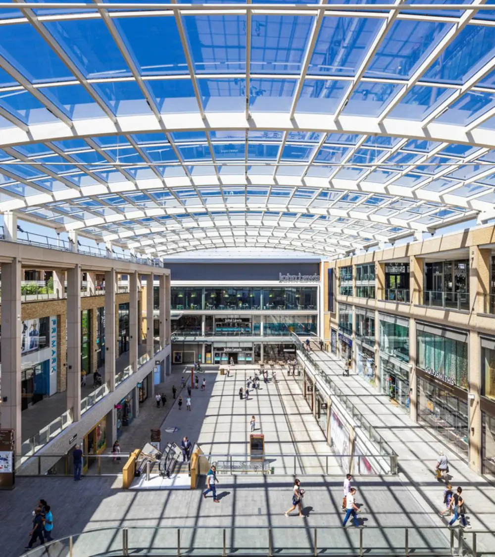 Modern shopping mall with glass ceiling skylight.